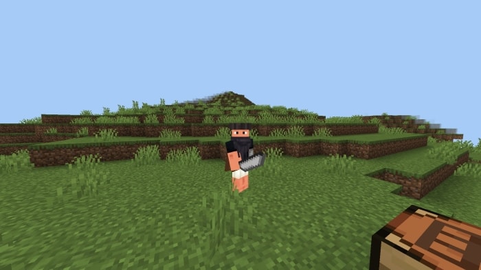 Player with new gear stands on grassy hill