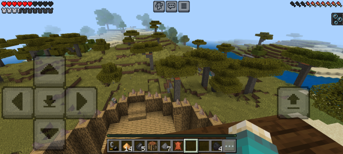 Player overlooks a fortified base and savanna.