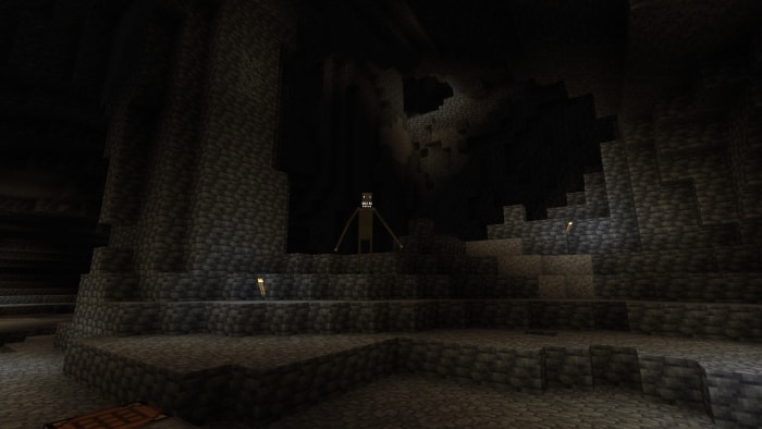 Dark cave with a tall, eerie creature lurking