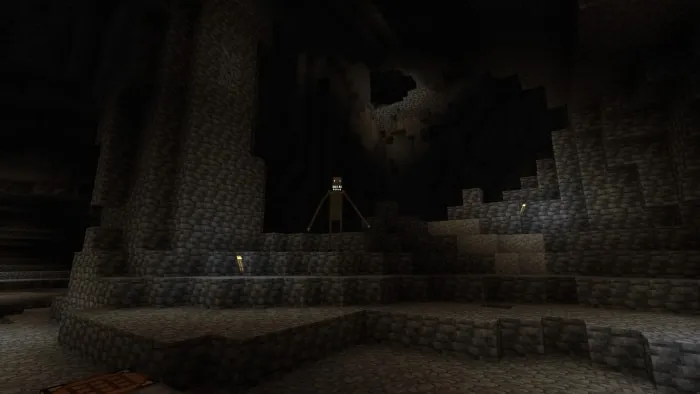 Dark cave with a tall, eerie creature lurking