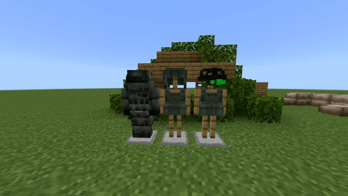 Three military armor sets on stands outdoors