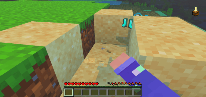 Player uncovers boots in sandy block.