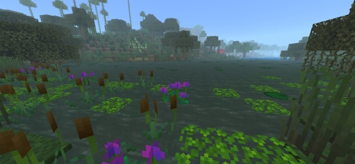 Dense swamp with vibrant flowers and fog