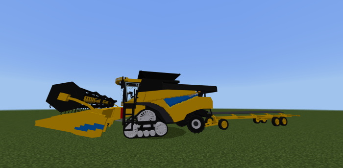 Yellow farm vehicle on grass field.