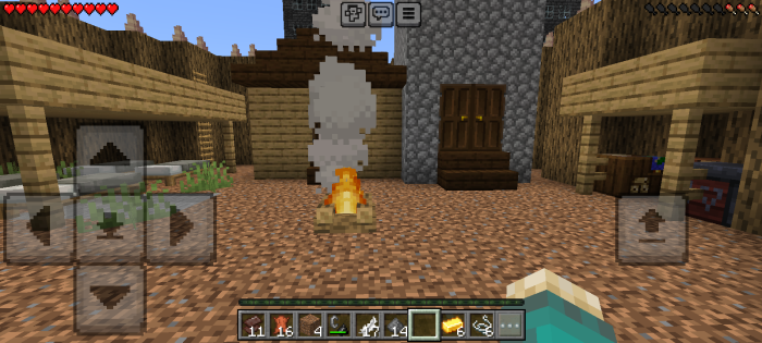 Campfire burning in a rustic, ruined village