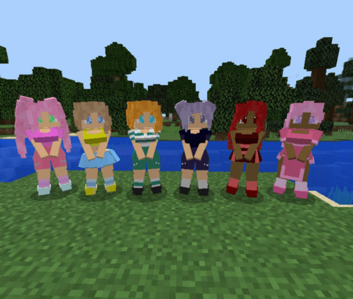 Colorful mermaids standing by the water.