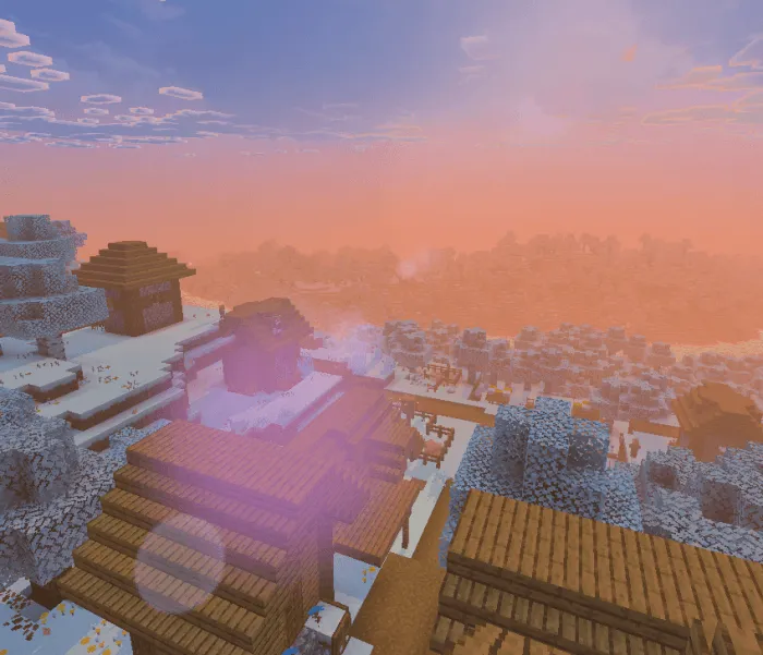 Snowy village with vibrant sunset sky