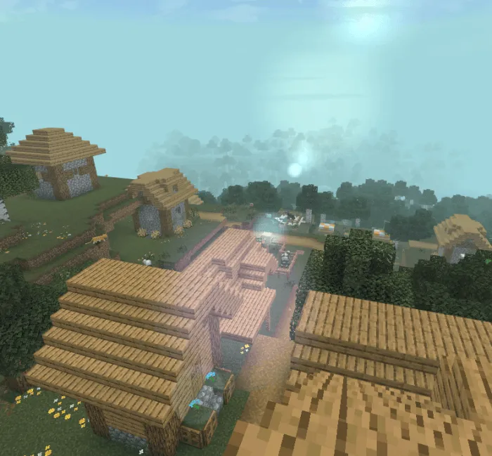 Soft sunlight and fog over village rooftops