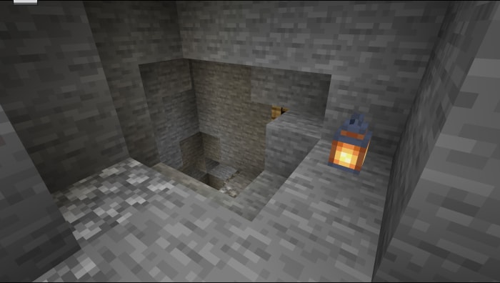 Stone mine entrance with lantern on the wall