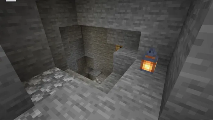 Stone mine entrance with lantern on the wall