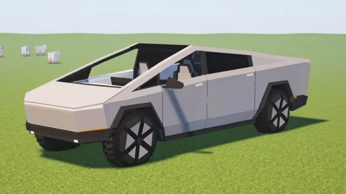 Blocky Tesla Cybertruck on grassy terrain