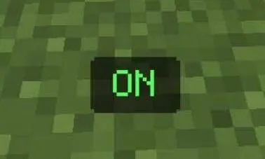 Green ON button displayed on a grassy block.