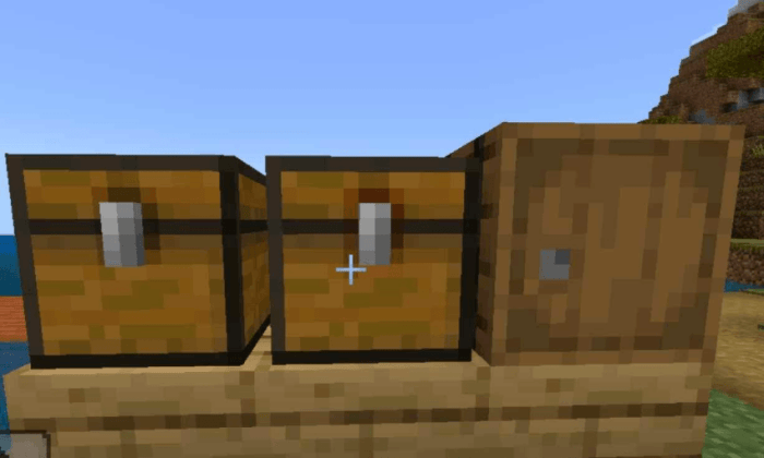 Two chests and a barrel on a wooden ledge