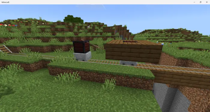 Custom minecart train on grassy tracks