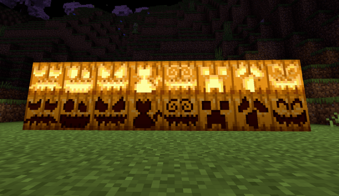 Row of carved pumpkin variants glowing at night