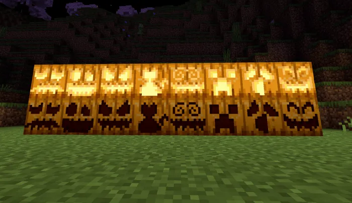 Row of carved pumpkin variants glowing at night