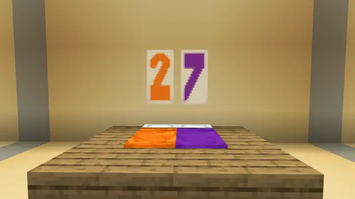 Bed with orange and purple blankets, 27 sign
