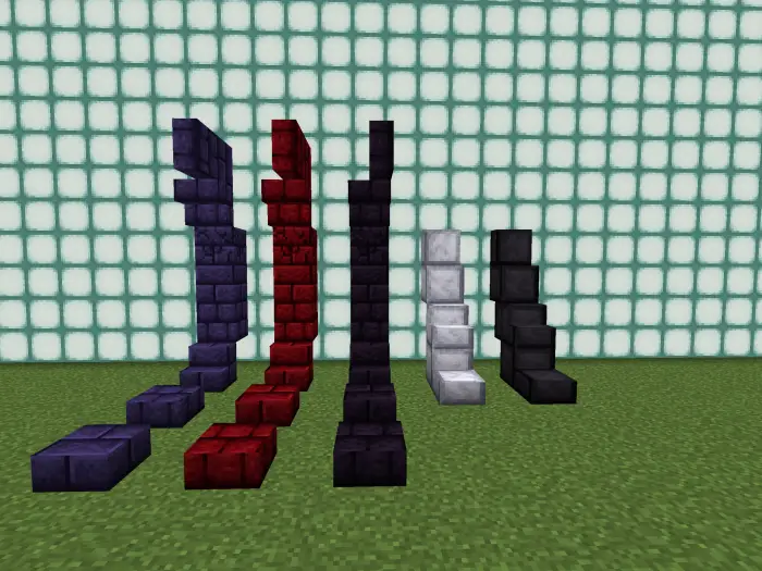 Five colored stair blocks in a row on grass.