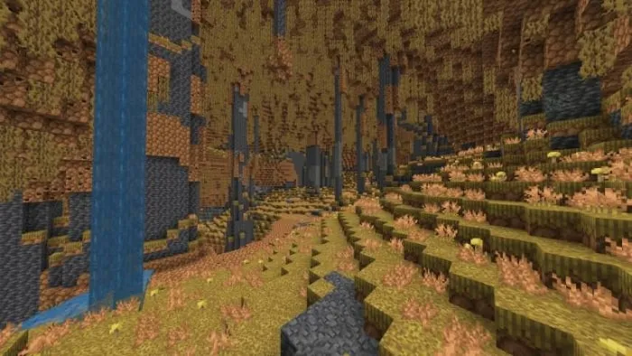 Lush cave biome with yellow foliage and waterfall