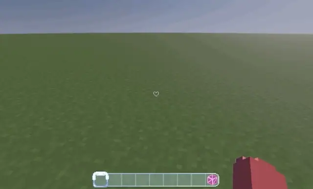 Empty grassy field with pink item in hand