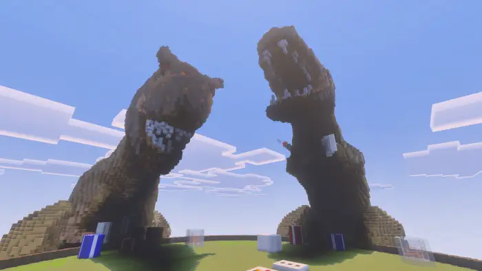 Two giant dinosaur statues face each other.