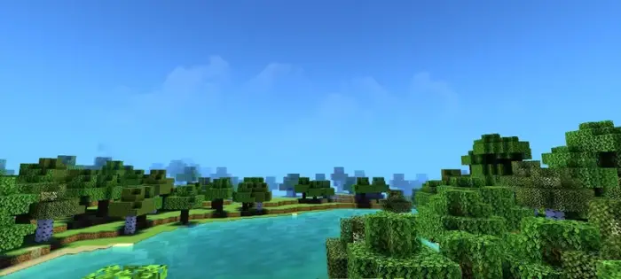 Lush forest and clear water with bright sky