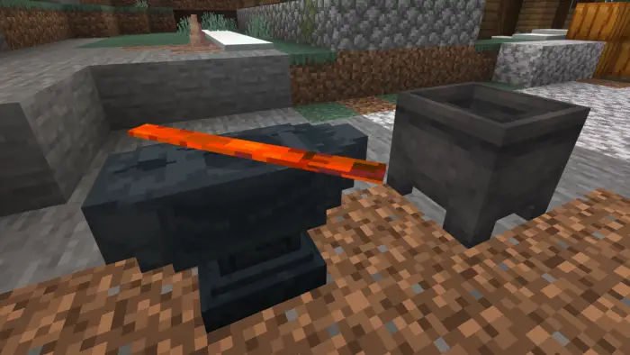 Heated metal ingot on anvil beside cauldron