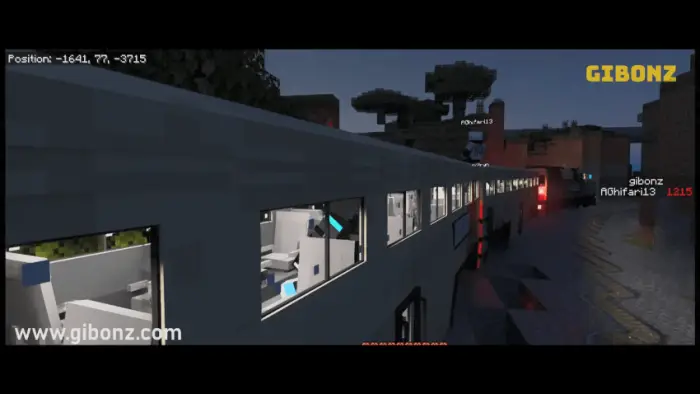 Blocky train with lit windows at dusk