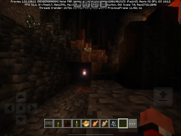 Glowing monster face in dark cave corridor