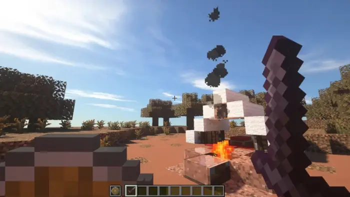 Round shield and sword near campfire