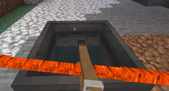 Tongs holding hot metal over a water trough