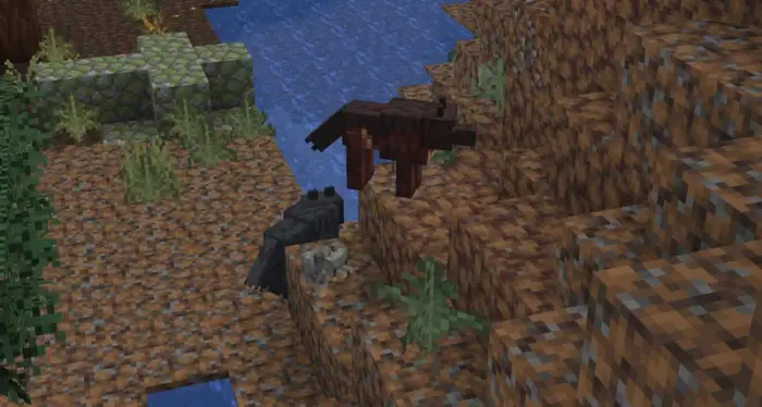 Two custom wolves on a hillside near water