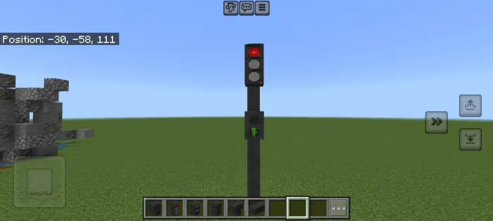 Traffic light on grassy terrain in-game.