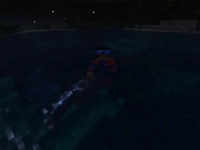 Player swimming underwater at night.