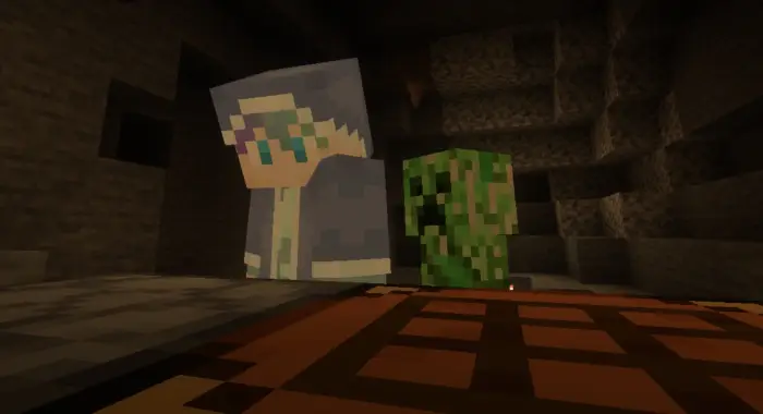 Player and creeper standing in a dark cave