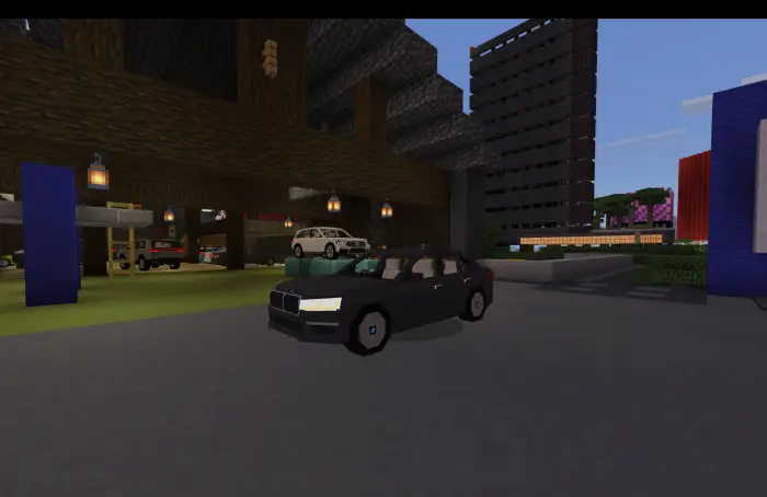 Blocky black sedan parked near a garage.
