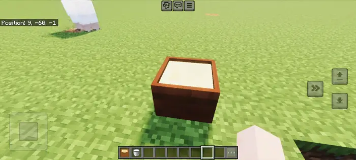 Square wooden planter on grassy ground