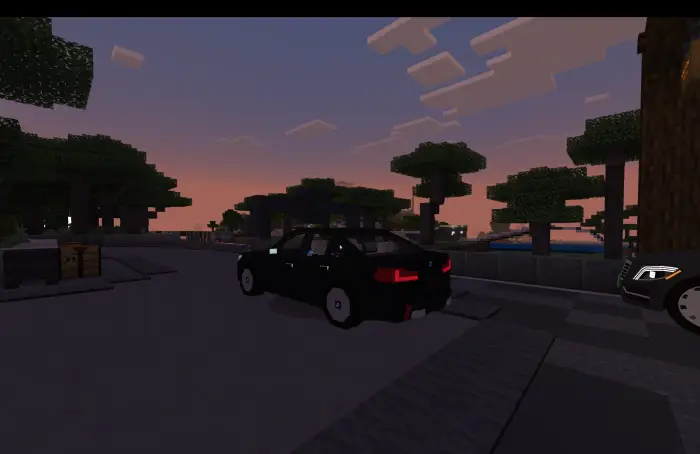 Blocky black BMW M5 sedan at sunset