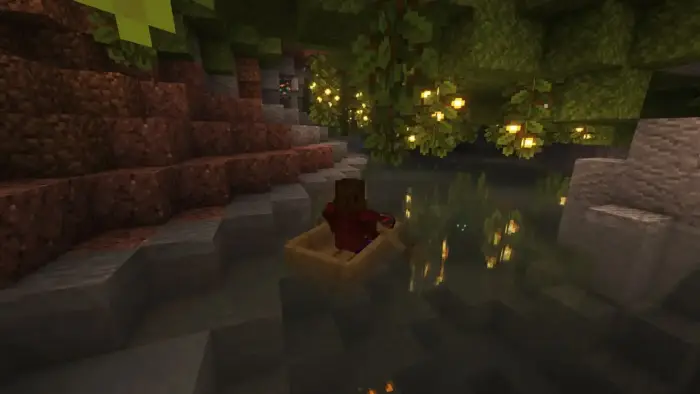 Player rows a boat through a glowing cave