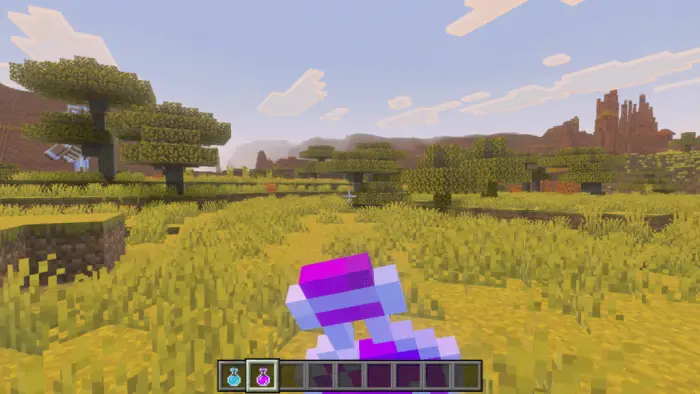 Player holding potion in grassy savanna biome