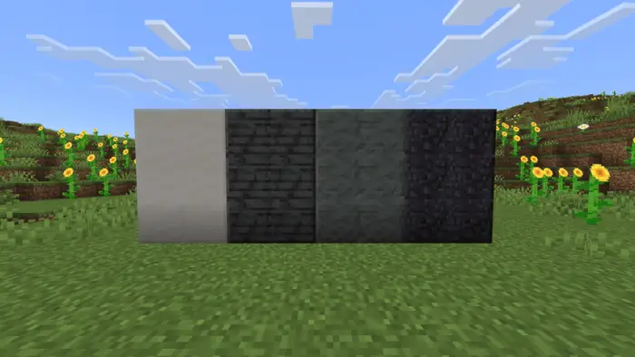 Four connected stone blocks on grassy field
