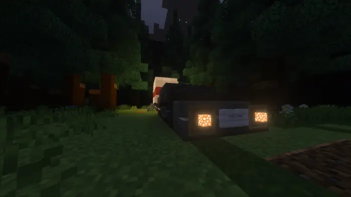 Car headlights in a dark, blocky forest