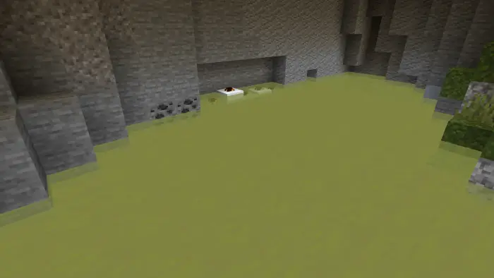 Yellow-tinted water in a stone cave.