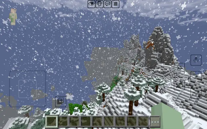 Light snow falls over blocky mountain terrain