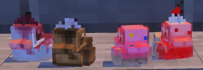 Four colorful rubber duck models in a row