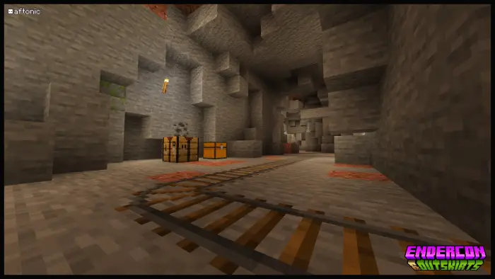 Minecart tracks and chests in a stone cave