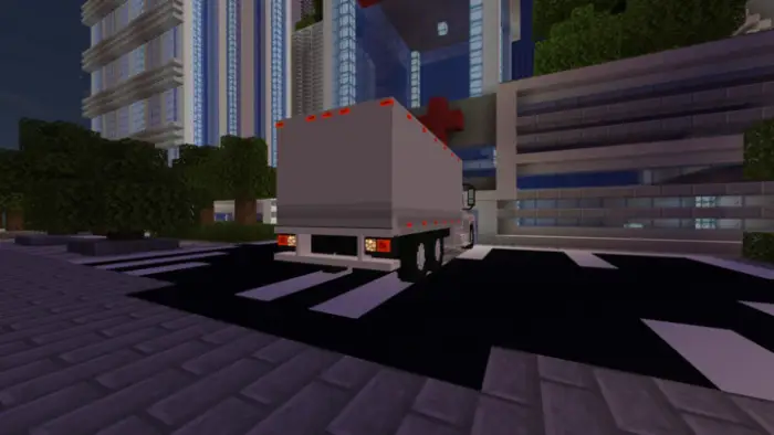 Box truck parked on a city street at night.
