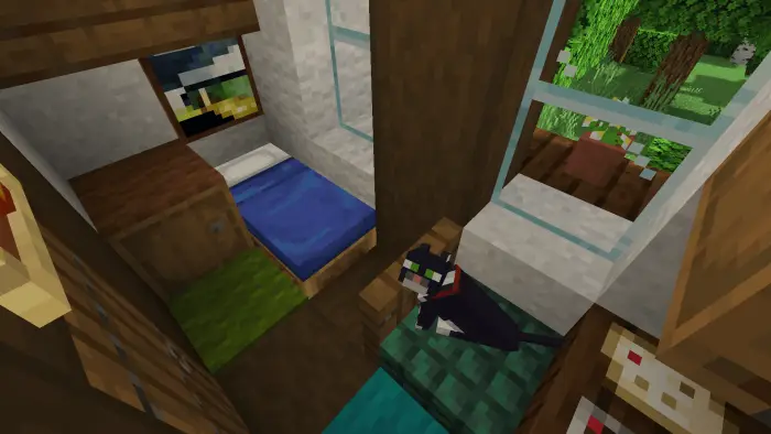 Small cozy bedroom with a cat and window view