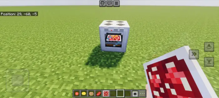 A modern oven with food in a grassy field