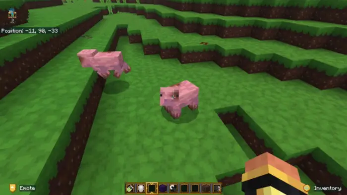 Two pigs on grassy block terrain in-game.